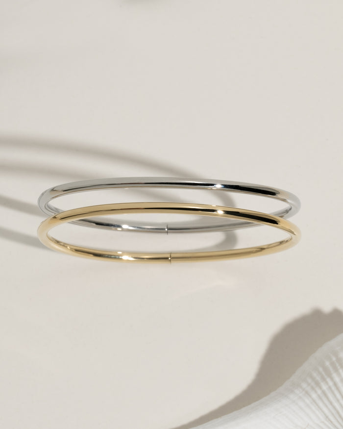 Stacked thin gold bangle bracelets