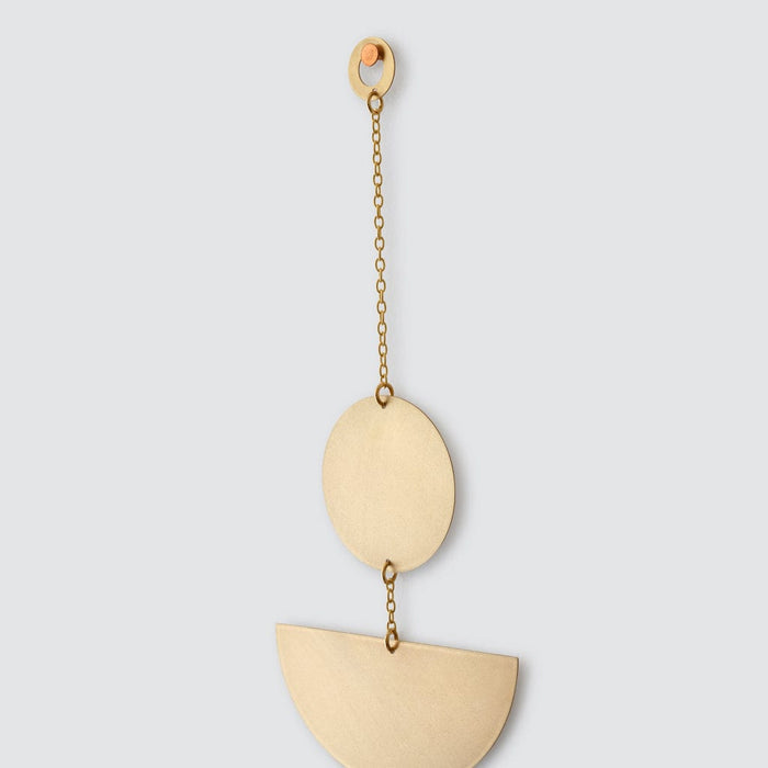 Detailed view of circular hanger for geometric brass wall hanging, brass