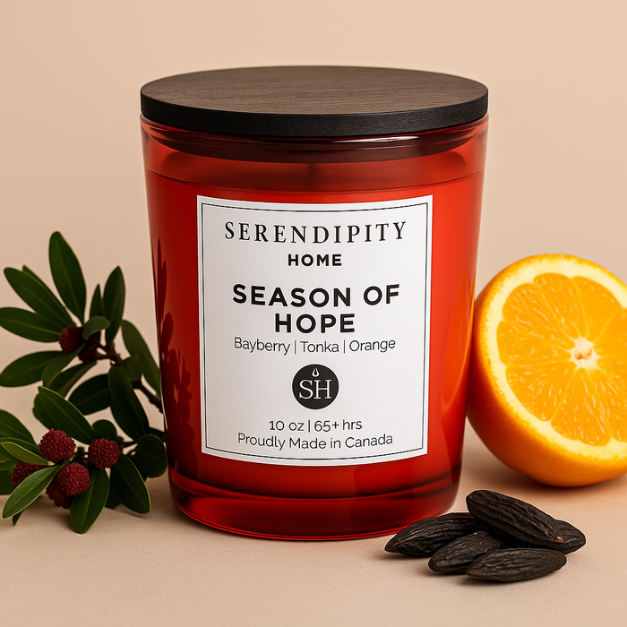 A Serendipity Home candle labeled 'Season of Hope' with an orange and leaves on a beige background
