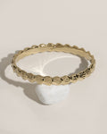 Gold beaded bracelet with tiny white shell charm pendant