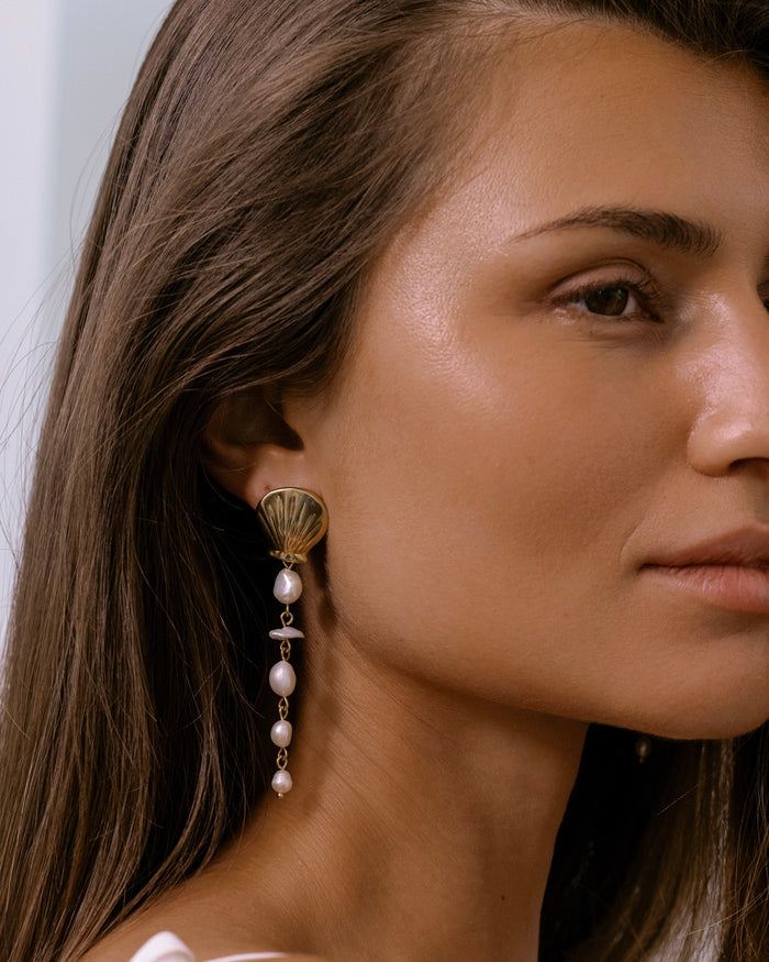 Long gold drop earrings with cascading freshwater pearl beads on hook wires