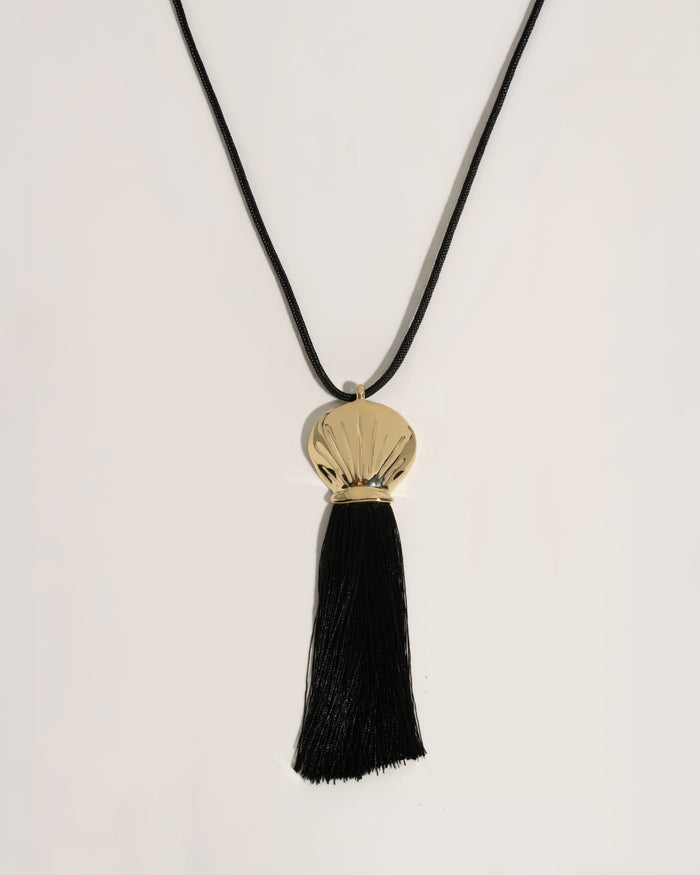 Gold necklace with a black pendant