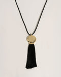 Gold necklace with a black pendant
