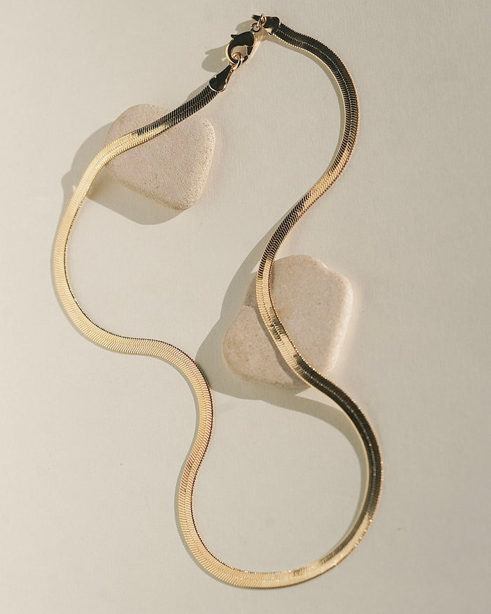 Wavy, swirl-shaped gold jewelry piece