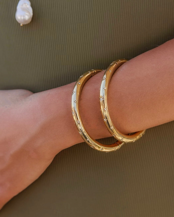 Gold bracelet with a starburst-shaped charm