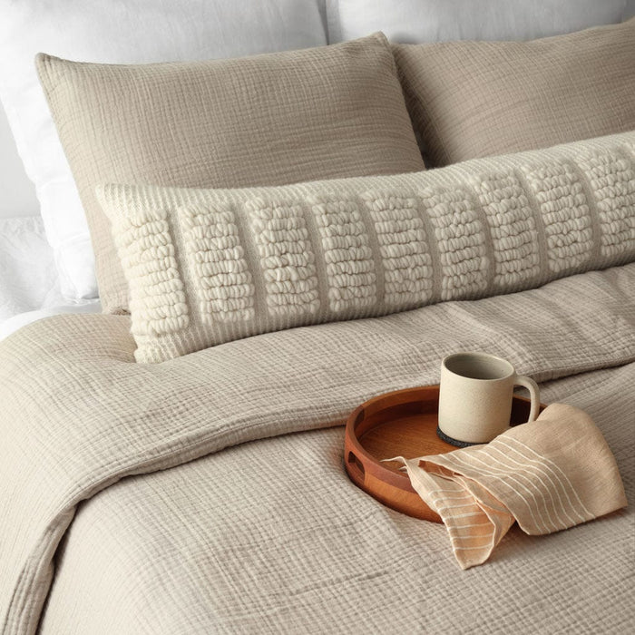 Ecru textured woven lumbar on bed, ecru