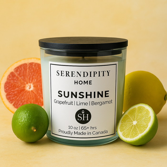 Scented candle labeled 'Sunshine' by Serendipity Home with citrus fruits on a yellow background