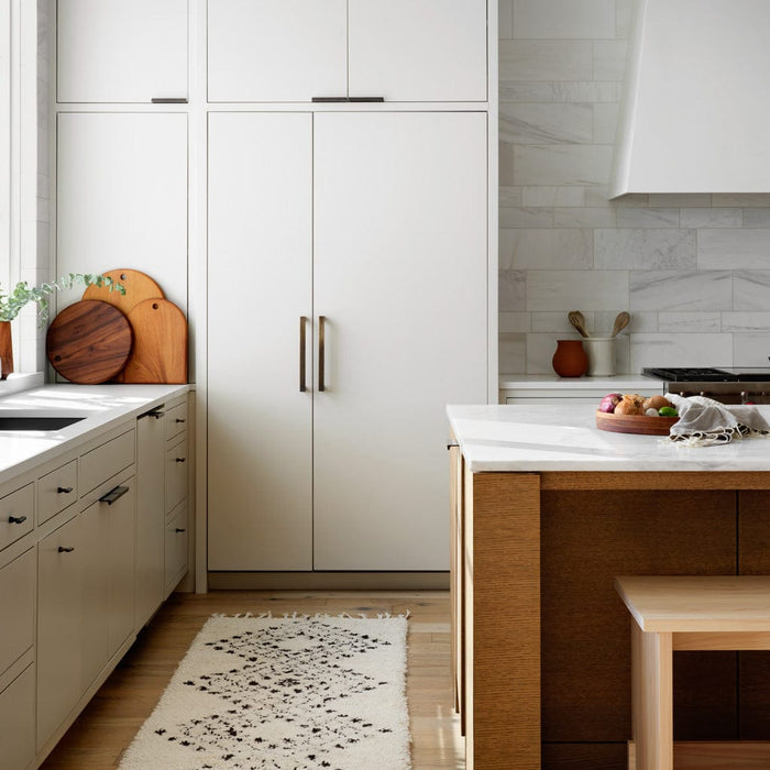 Round and arched wooden charcuterie boards styled in white modern kitchen, mahogany