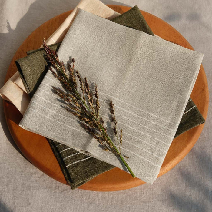 Wooden charcuterie board styled with linen napkins in muted tones, mahogany