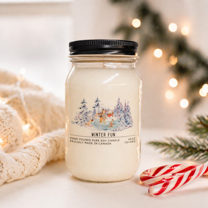 Jar candle labeled 'Winter Fun' with Christmas decorations in the background