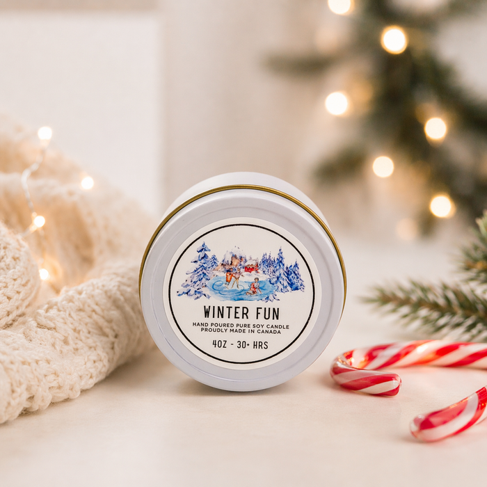 Candle jar labeled 'Winter Fun' with Christmas decorations in the background